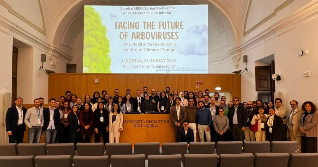 EuroNet MRPH residents at the 2026 Spring Meeting in L'Aquila, in front of the meeting banner.